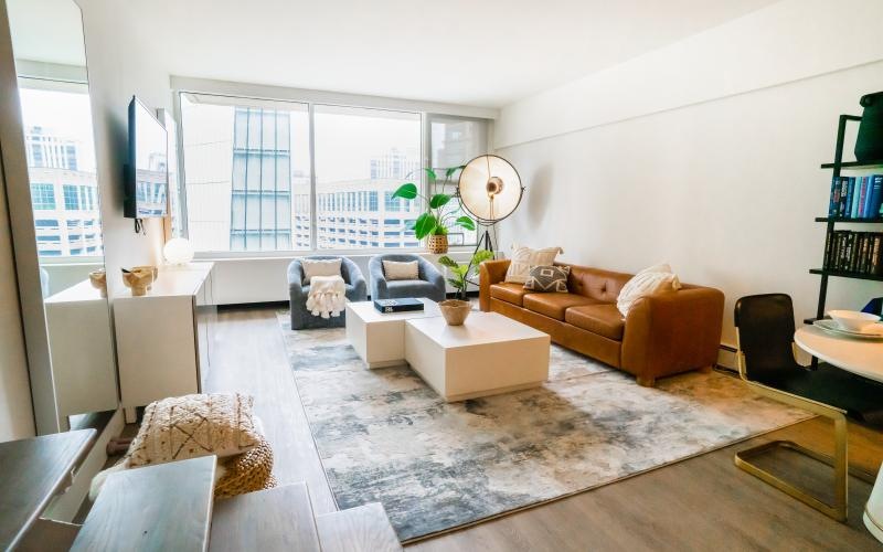 a living room with a rug and couches