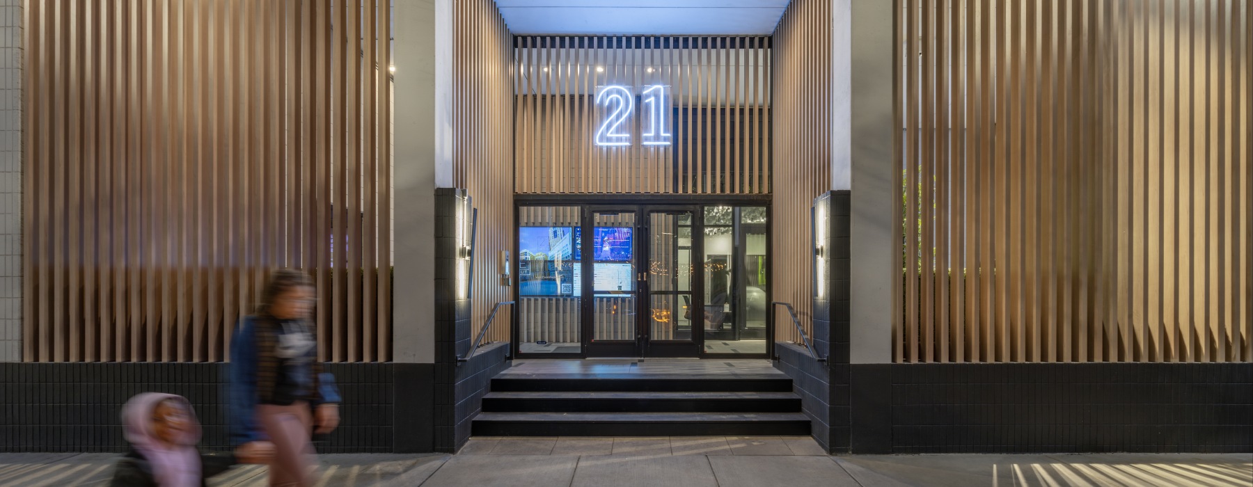 ront entrance of 21 E Chestnut featuring modern architectural details, clean landscaping, and a welcoming residential entryway.