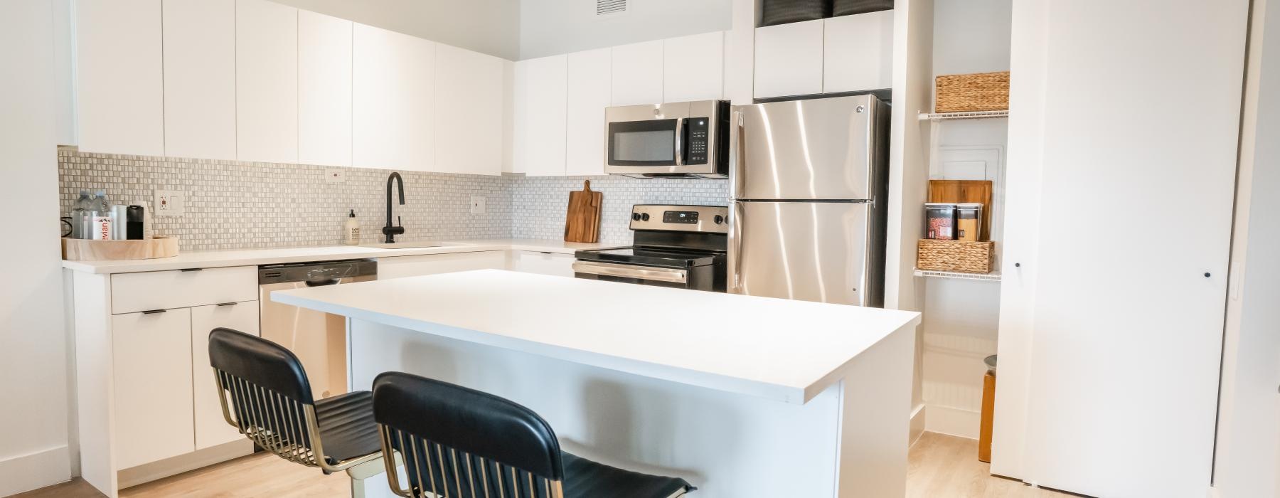 a kitchen with white cabinets