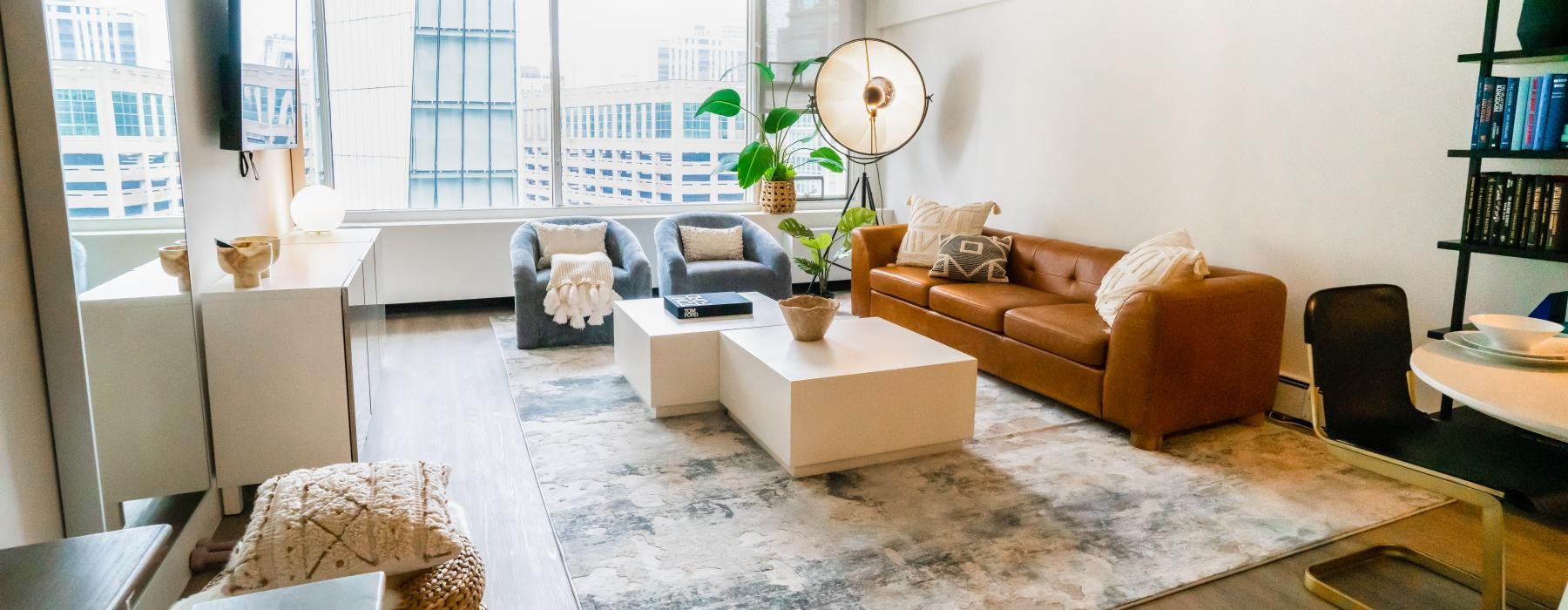 a living room with a rug and couches